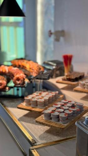 a buffet of food with cupcakes and other foods at SEAVIEW HOTEL in Umm Lujj