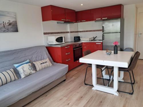 - une cuisine avec un canapé et une table dans une chambre dans l'établissement Chez Ophélie et Gaël, à Saint-Malo
