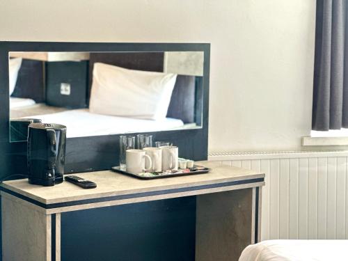 a table in a hotel room with a bed at Hotel Express Newcastle Gateshead in Newcastle upon Tyne