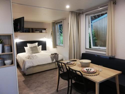 a bedroom with a bed and a table with chairs at Agricampeggio Cà di Mazza in Monzuno
