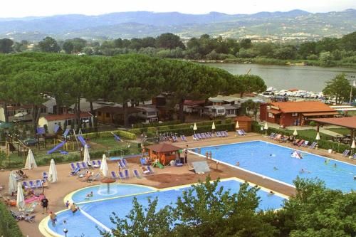 a large swimming pool next to a large body of water at Bungalow 477 Colibrì in Ameglia