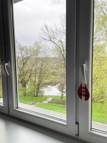 an open window with a view of a park at V5 central in Valmiera