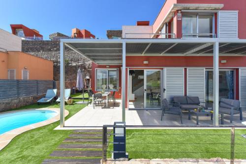 a home with a patio and a pool at Vista Golf 5 by Villagrancanaria in La Playa de Arguineguín