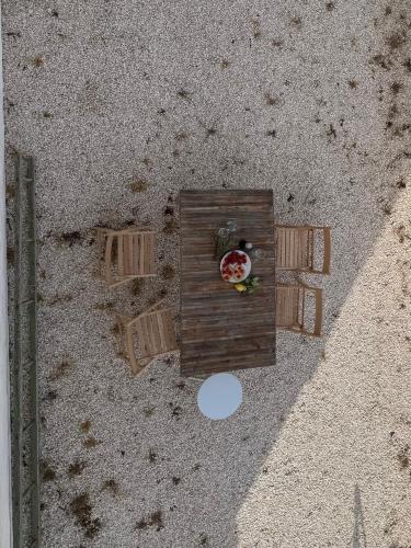 a small wooden bird house with a flower in it at Ma'Bella - MASSERIA PICCOLA by Rentbeat in Cisternino