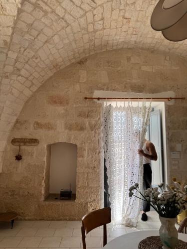 a room with a stone wall and a window at Ma'Bella - MASSERIA PICCOLA by Rentbeat in Cisternino