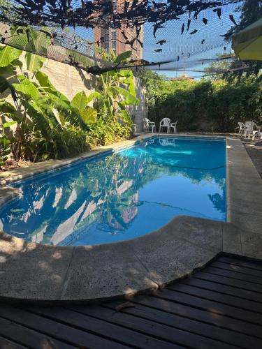 a swimming pool with blue water in a yard at Posada de San Isidro in San Isidro