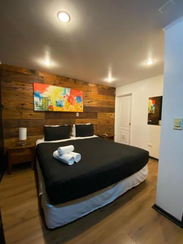 a bedroom with a large bed with towels on it at Tremo Bustamante in Santiago