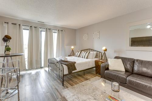 a living room with a bed and a couch at 8 Mi to Traverse City Bayside Couples Retreat in Williamsburg