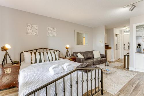 a bedroom with a bed and a couch at 8 Mi to Traverse City Bayside Couples Retreat in Williamsburg