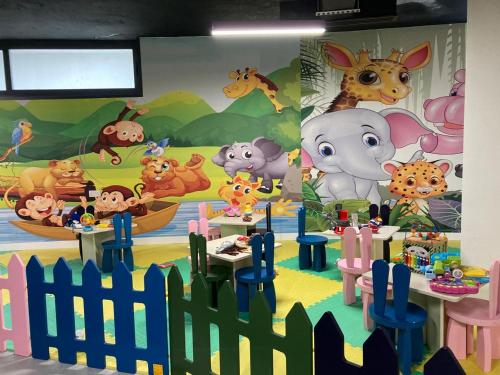 a childrens play area with animals painted on the wall at Azure Seaview Studio in Priscilla, Caesar Blue Resort, Gym, Heated pool, Sauna, Late check-out in Kalecik