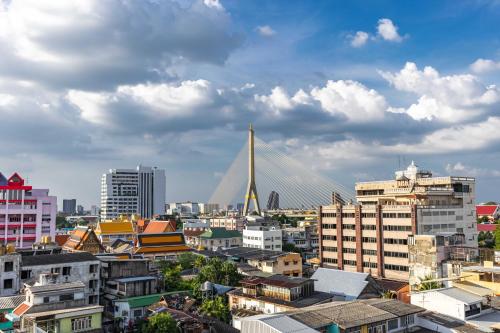 a view of a city with a bridge in the background at Diamond House Khaosan in Bangkok