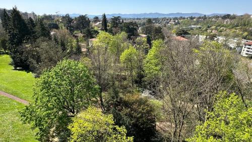 une vue sur une forêt plantée d'arbres et de bâtiments dans l'établissement Lyon Tassin appartement proche Métro bus parking possible, à Vaise