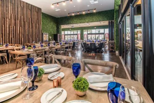 a dining room with wooden tables and chairs at Premium Home, 7 min from Disney in Orlando