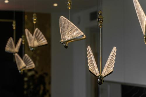 a group of butterflies hanging on a wall at Goldstar Apartament- Wanna z widokiem, 19 Piętro, Hanza Tower Szczecin in Szczecin