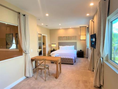 a bedroom with a bed and a desk and a table at Family Home W Bbq, 7 Min From Disney, Accessible in Orlando