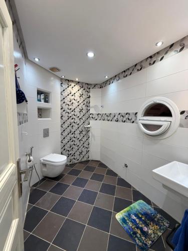 a bathroom with a toilet and a sink at Sea View Apartment in Mirleft