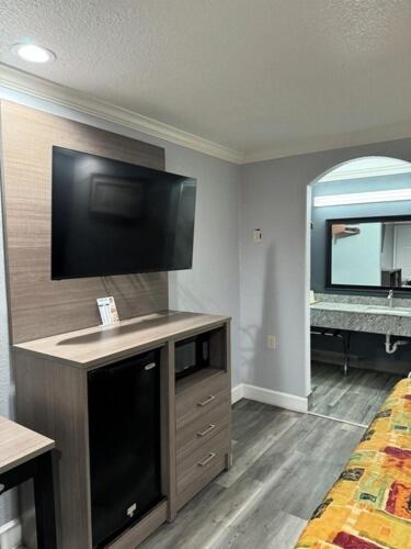 a room with a flat screen tv on the wall at Luxury inn in Houston