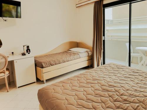 a bedroom with a bed and a desk and a table at Hotel President - Vintage Hotel in centro in Riccione