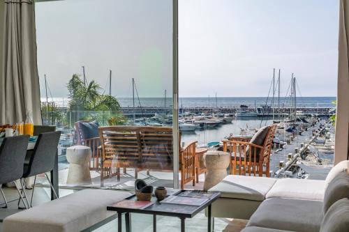 a living room with a view of a marina at 243-Fully Renovated-Puerto Banus Marbella Front Line Penthouse in Marbella