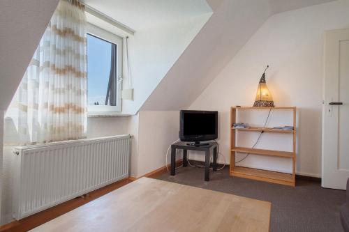 a living room with a tv and a window at Obst- und Ferienhof Lehle in Immenstaad am Bodensee