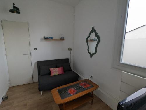 a living room with a chair and a coffee table at Little house with small courtyard in Bordeaux