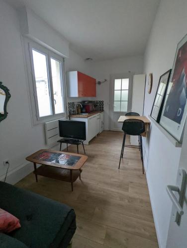 a living room with a couch and a table at Little house with small courtyard in Bordeaux