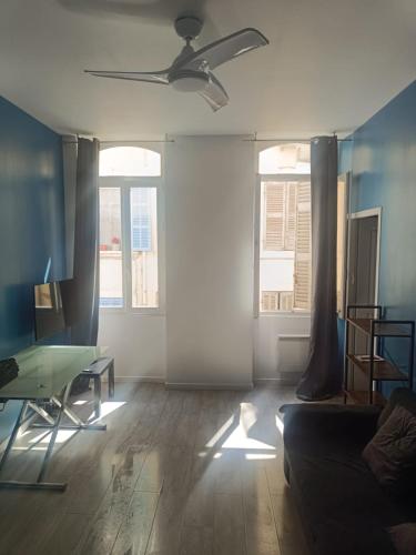 un salon avec un canapé et un ventilateur de plafond dans l'établissement Beau 2 pieces Vieux port de Marseille, à Marseille