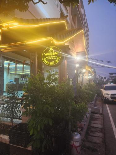 a restaurant with a sign on the side of a building at Vientiane Luxury Hotel in Vientiane