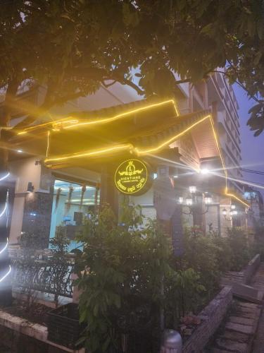 a restaurant with a yellow sign on the side of a building at Vientiane Luxury Hotel in Vientiane