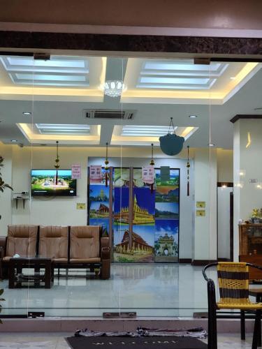 a lobby with a couch and a tv on the wall at Vientiane Luxury Hotel in Vientiane