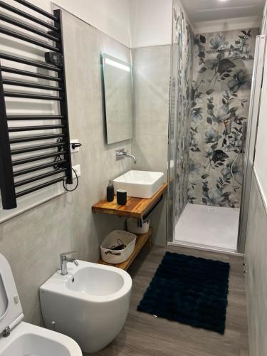 a bathroom with a toilet and a sink and a shower at Klimt & Van Gogh Vista Lago by Abitare Il Tempo in Nemi