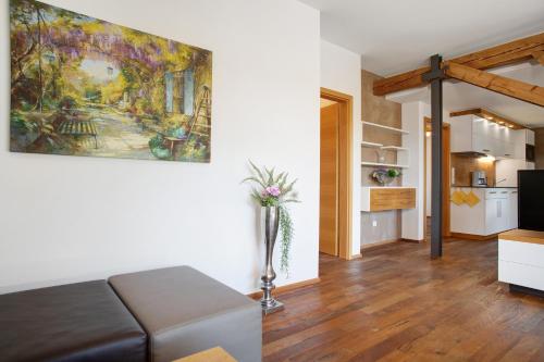 a living room with a couch and a painting on the wall at Obst- und Ferienhof Lehle in Immenstaad am Bodensee