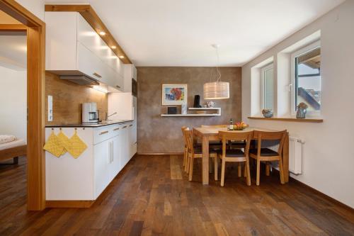 a kitchen and dining room with a table and chairs at Obst- und Ferienhof Lehle in Immenstaad am Bodensee