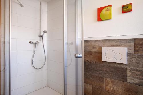 a bathroom with a shower with a glass door at Obst- und Ferienhof Lehle in Immenstaad am Bodensee