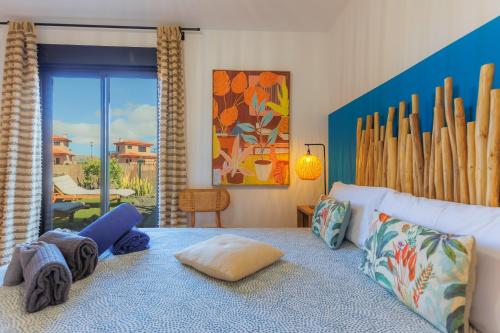 a bedroom with a bed with pillows on it at Alma Ventura - A Peaceful Getaway in Majanicho in Majanicho