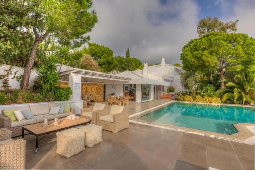 a house with a swimming pool and a patio at Super Luxury Skiathos Villa Seven Stunning Bedroom Suites Villa Daphne Achliades in Achladies