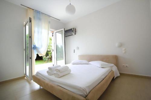 a bedroom with a bed with towels on it at Luxury Zante Villa Zante Vista Villa Private Pool Seaviews Agios Sostis in Laganas