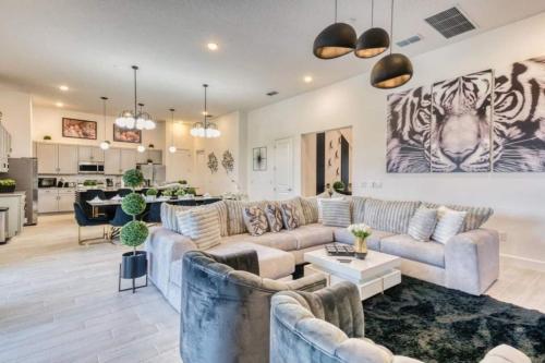 a large living room with couches and a kitchen at Experience Luxury In Your 11 En-suites Mansion in Orlando