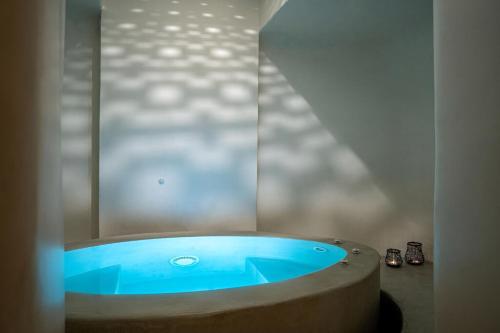 a bathroom with a blue tub in a room at Wonderful Santorini Villa 1 Bedroom Villa Gonia Astonishing Views & Outdoor Jacuzzi Exo Gonia in Éxo Goniá