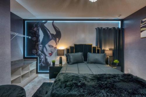 a bedroom with a bed with a picture of a woman at Experience Luxury In Your 11 En-suites Mansion in Orlando