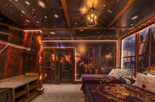 a room with two beds and a painting on the wall at Experience Luxury In Your 11 En-suites Mansion in Orlando