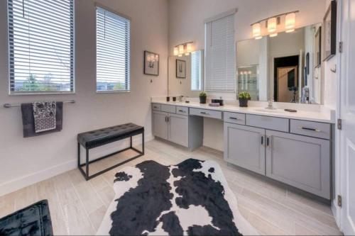 a bathroom with a black and white cow rug at Experience Luxury In Your 11 En-suites Mansion in Orlando