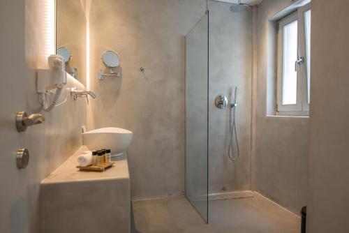 a bathroom with a glass shower and a sink at Beautiful Paros Villa 1 Bedroom The Calming Villa Wonderful Sea Views & Jacuzzi Naousa in Livadia