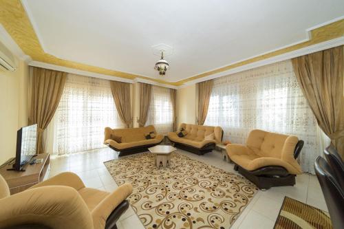 a large living room with couches and a tv at Avsallar Kepenek Village in Avsallar