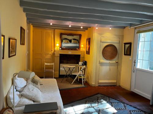 a living room with a couch and a table at Le Belvédère,double room in Bléré