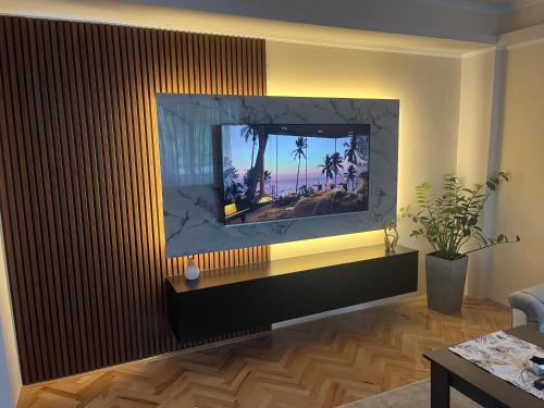 a living room with a flat screen tv on a wall at Mitrovi Apartment in Gevgelija