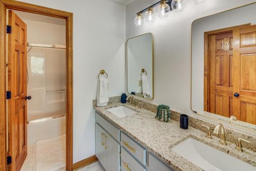 a bathroom with two sinks and a large mirror at Walk to Marina Water-View Dale Hollow Lake Escape in Celina