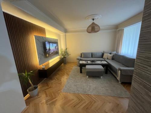 a living room with a couch and a tv at Mitrovi Apartment in Gevgelija