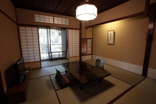 a room with a couch in a room with windows at Motoyu Ishiya in Kanazawa