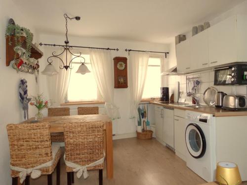 a kitchen with a table and a sink and a table and chairs at Ferienhäusel am Malerweg mit Terrasse in Bad Schandau
